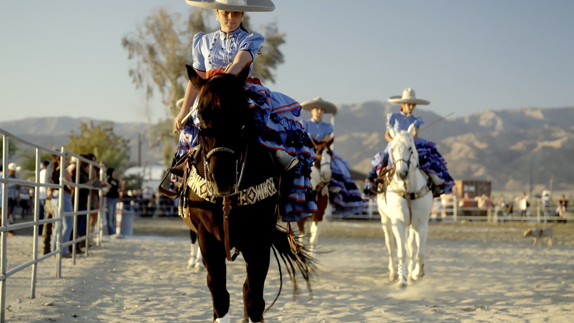 Escaramuza charra in traditional ruffled dress on horseback at Rancho Escondido in Indio, California.