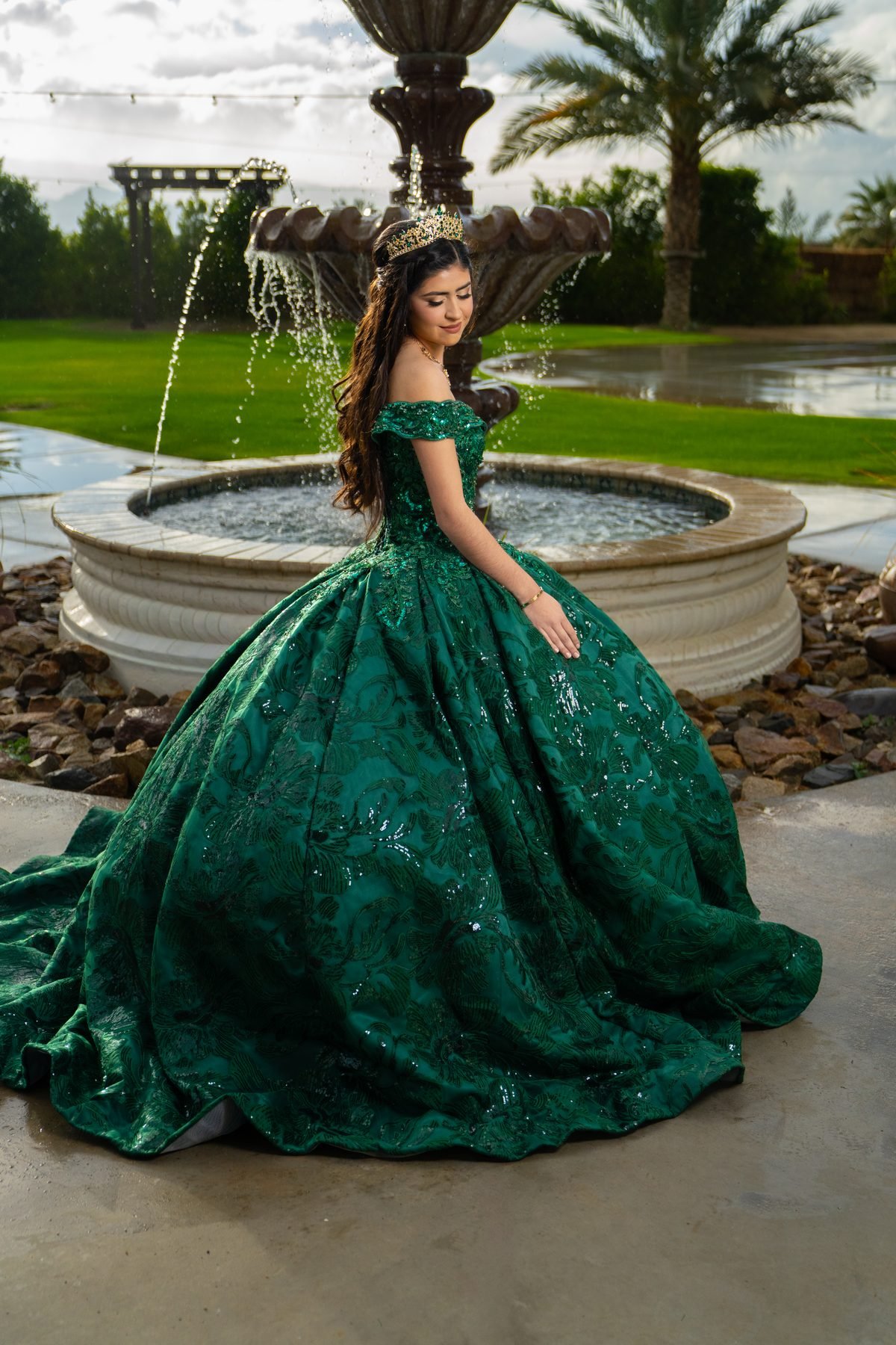 Quinceañera portrait in emerald sequined ball gown at the tiered fountain at Rancho Escondido in Indio.