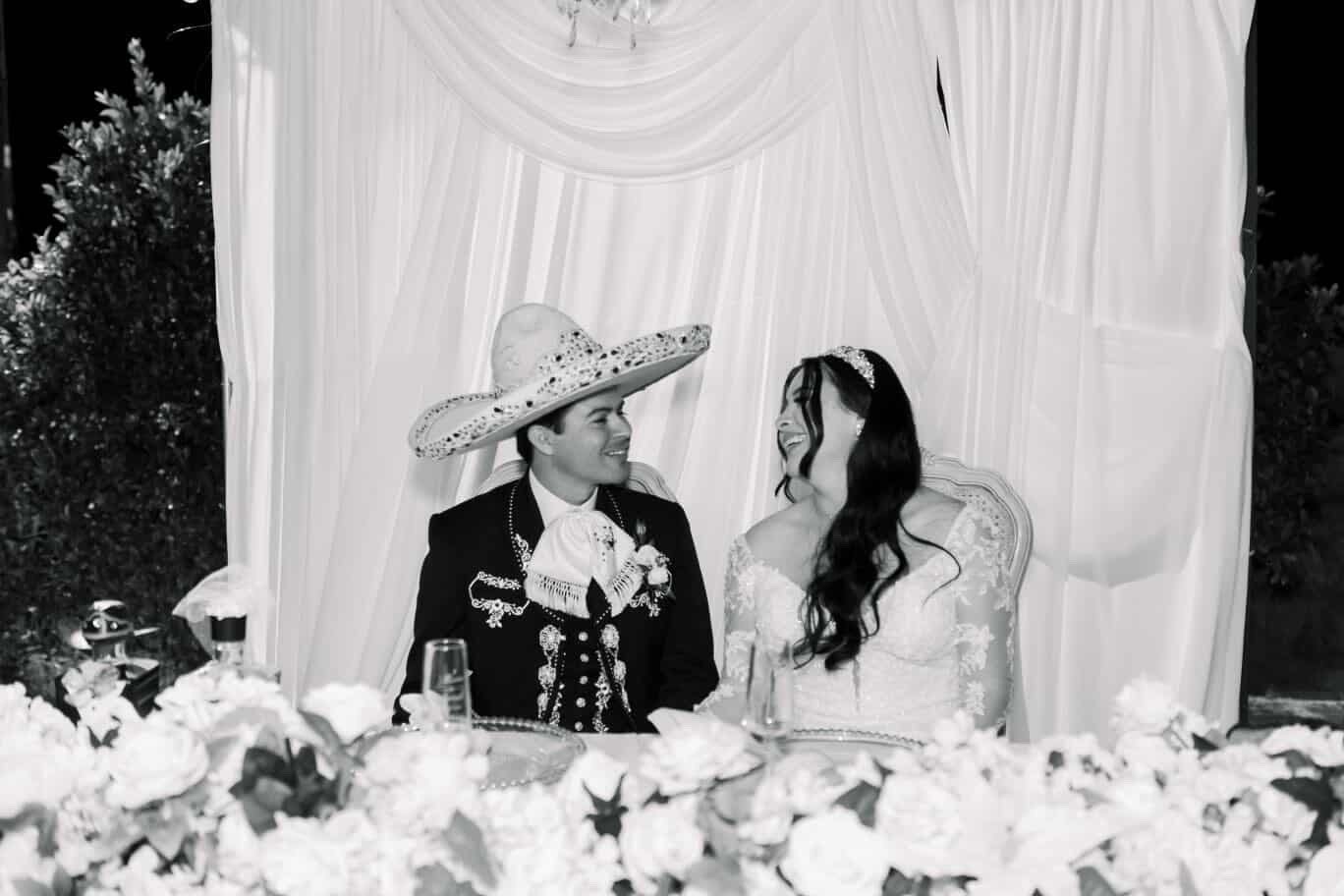 Black and white sweetheart table portrait of bride and groom at Rancho Escondido wedding in Indio.